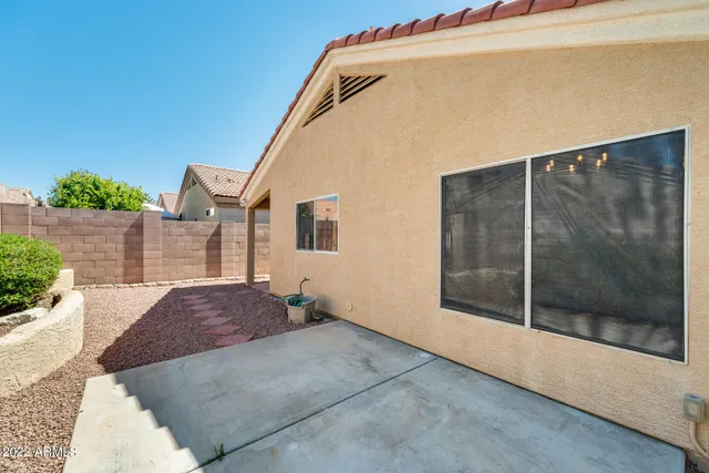 a view of backyard with small cabin and wooden fence