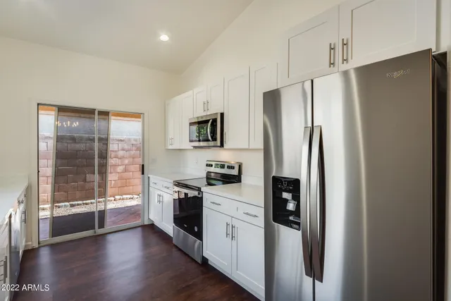 a kitchen with stainless steel appliances a refrigerator stove and sink