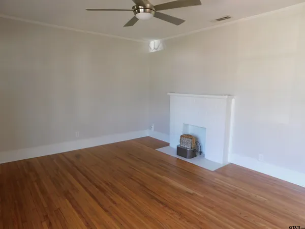 a view of an empty room and wooden floor