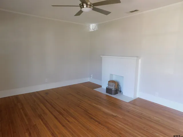 a view of an empty room and wooden floor