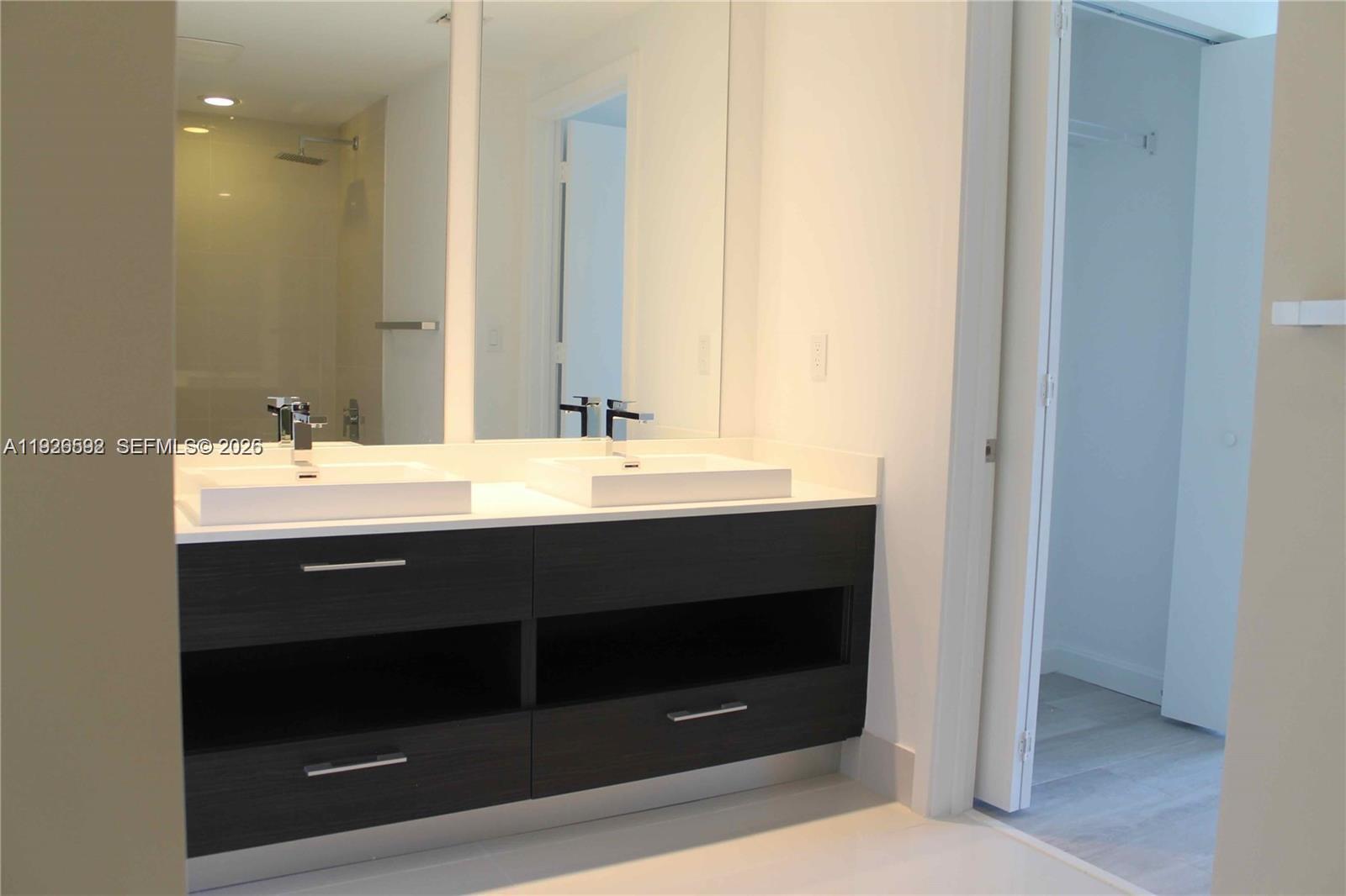 45 Southwest 9th Street, Unit 2209 Miami, FL 33130 - Photo 12 of 31 a bathroom with a sink and a mirror