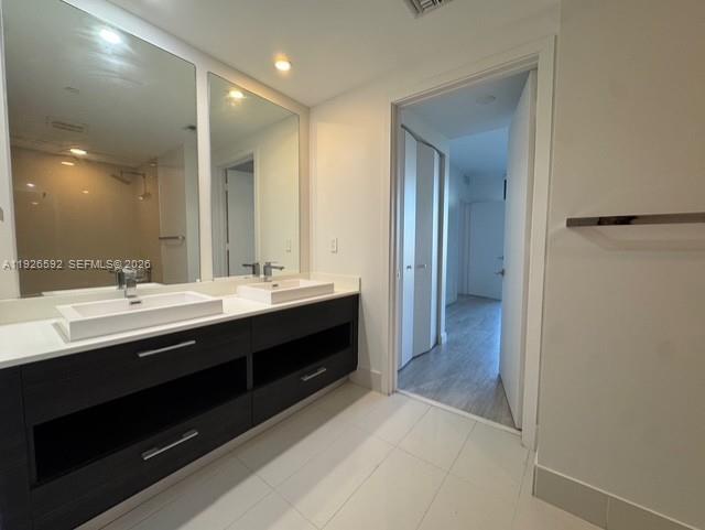 45 Southwest 9th Street, Unit 2209 Miami, FL 33130 - Photo 13 of 31 a bathroom with a double vanity sink a and mirror