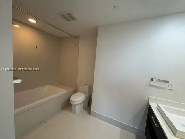 a bathroom with a sink a toilet and bathtub