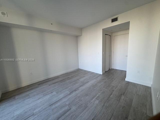 45 Southwest 9th Street, Unit 2209 Miami, FL 33130 - Photo 16 of 31 a view of an empty room with wooden floor and closet