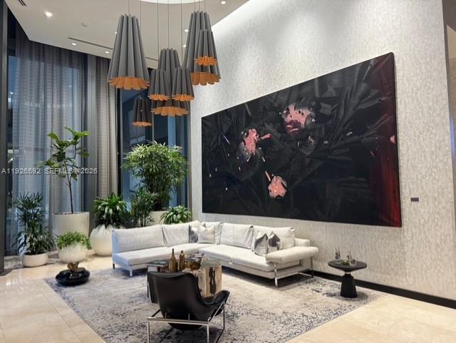 45 Southwest 9th Street, Unit 2209 Miami, FL 33130 - Photo 20 of 31 a living room with furniture potted plant and a painting on the wall