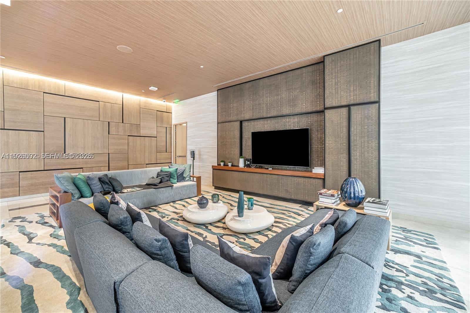 45 Southwest 9th Street, Unit 2209 Miami, FL 33130 - Photo 23 of 31 a living room with furniture and a flat screen tv