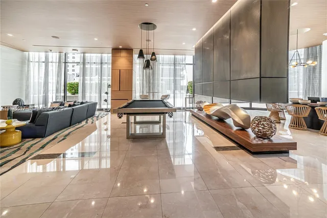 a living room with furniture and large windows