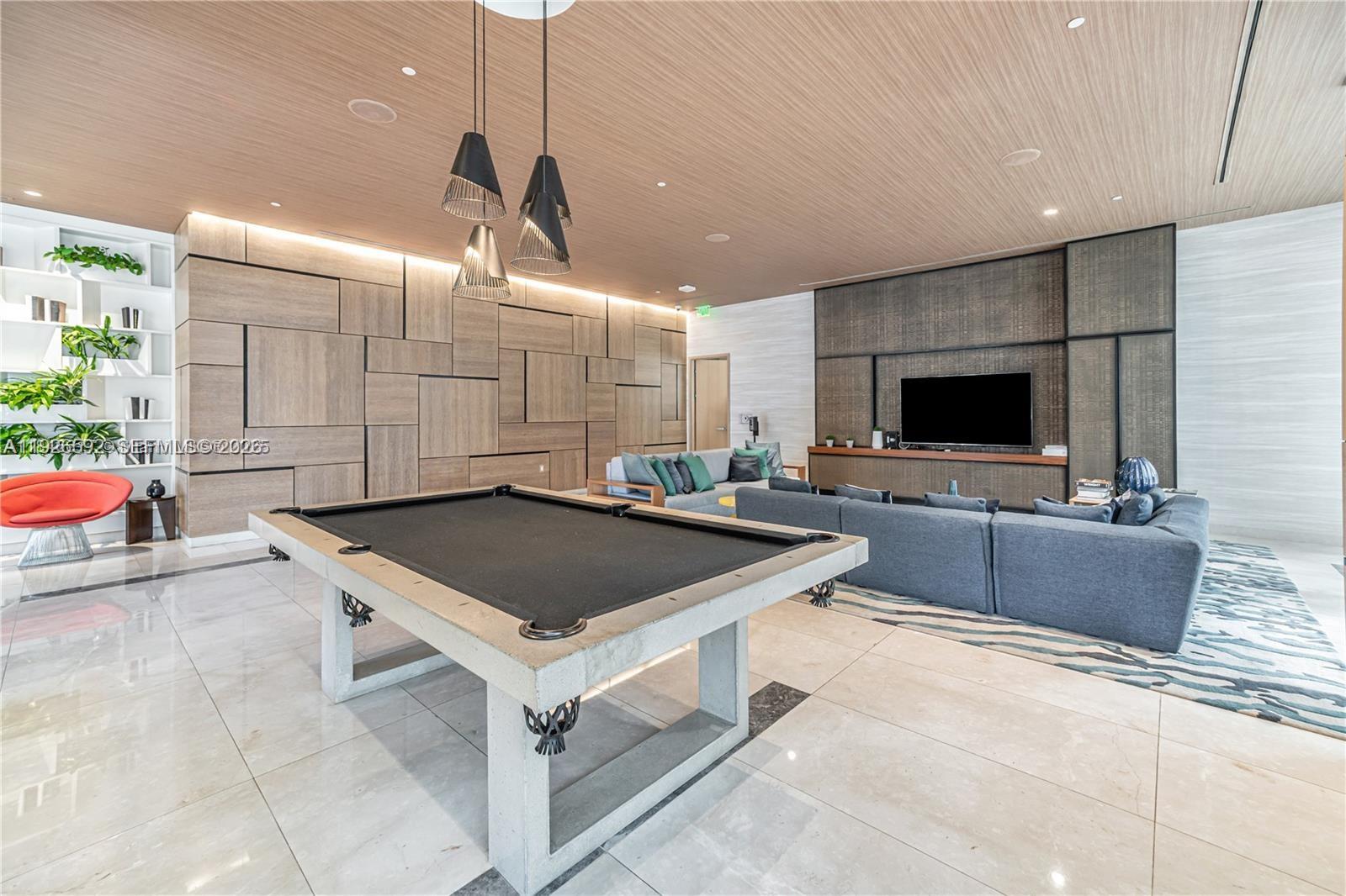 45 Southwest 9th Street, Unit 2209 Miami, FL 33130 - Photo 24 of 31 a kitchen with stainless steel appliances granite countertop a sink a stove and a wooden floors