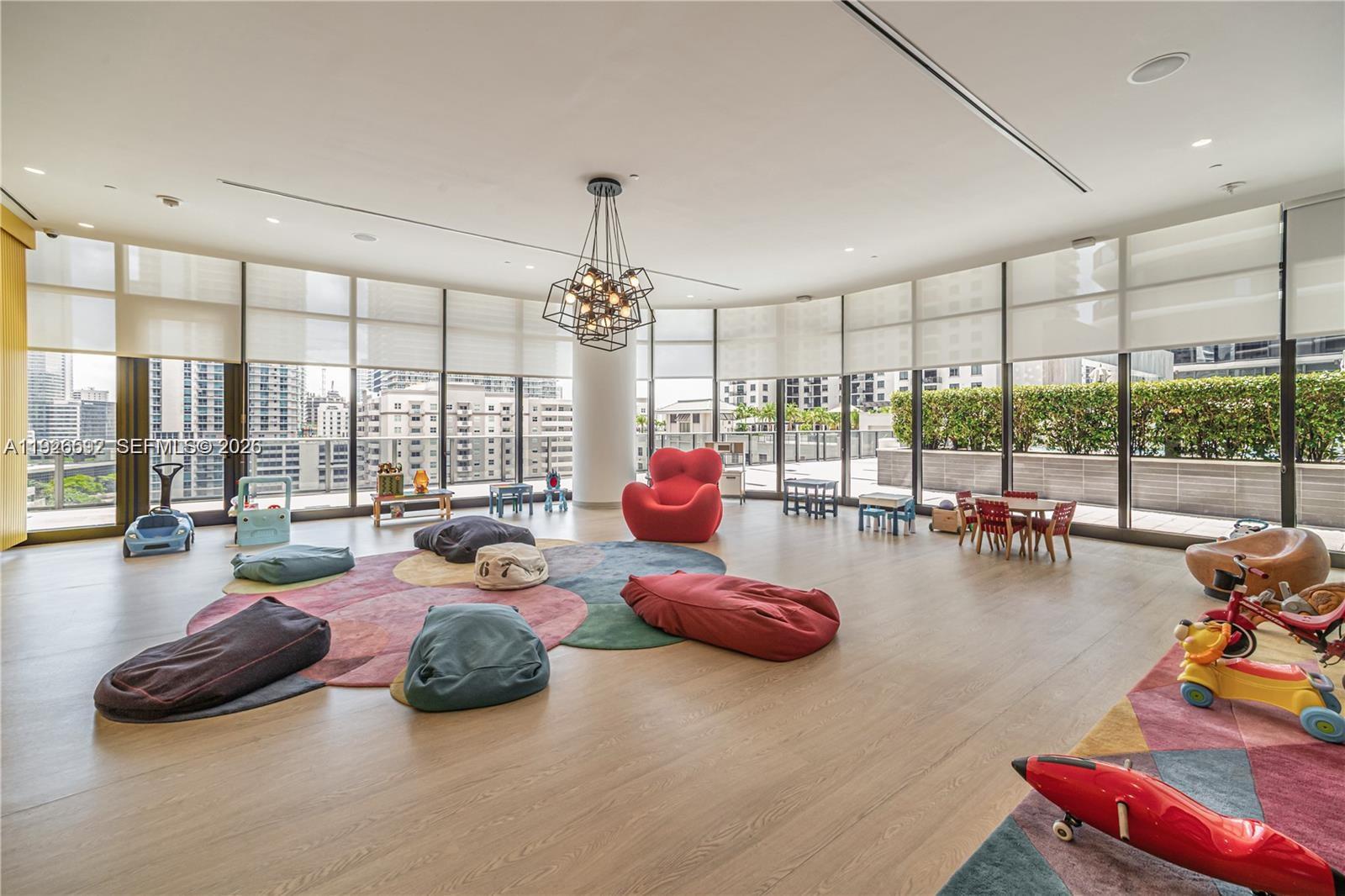 45 Southwest 9th Street, Unit 2209 Miami, FL 33130 - Photo 29 of 31 a room with gym equipment and large windows