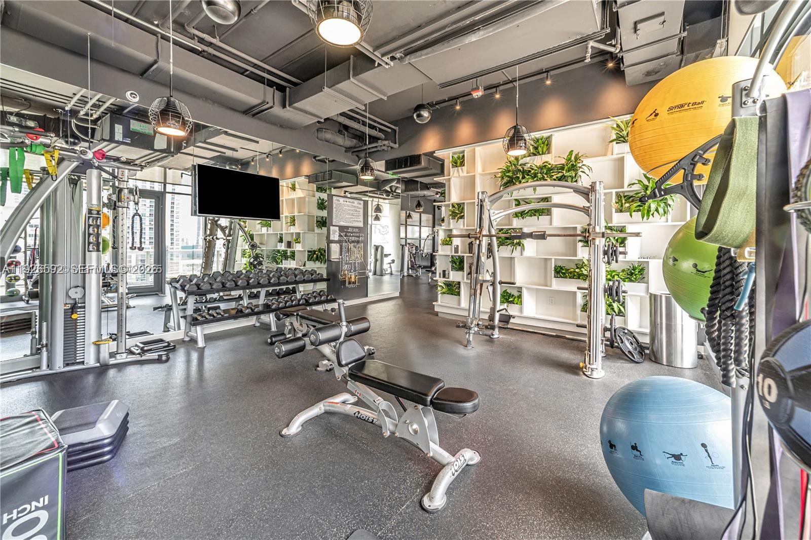 45 Southwest 9th Street, Unit 2209 Miami, FL 33130 - Photo 30 of 31 a view of a room with gym equipment