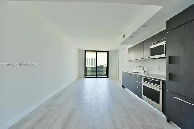 a kitchen with a stove a sink and a refrigerator