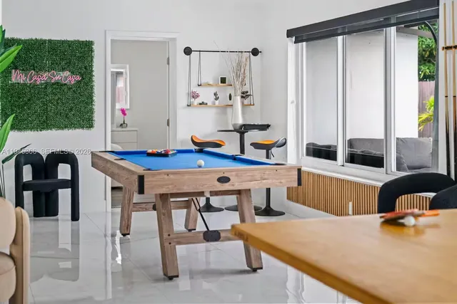 a dining room with furniture and window