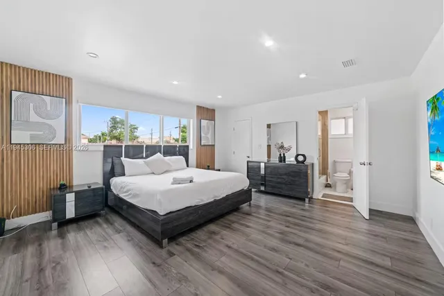 a spacious bedroom with a bed and a large window