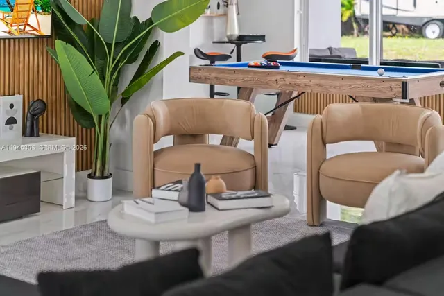 a view of a dining room with furniture a fireplace and wooden floor