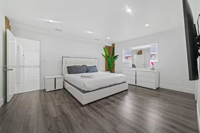 a bedroom with a bed and a dresser