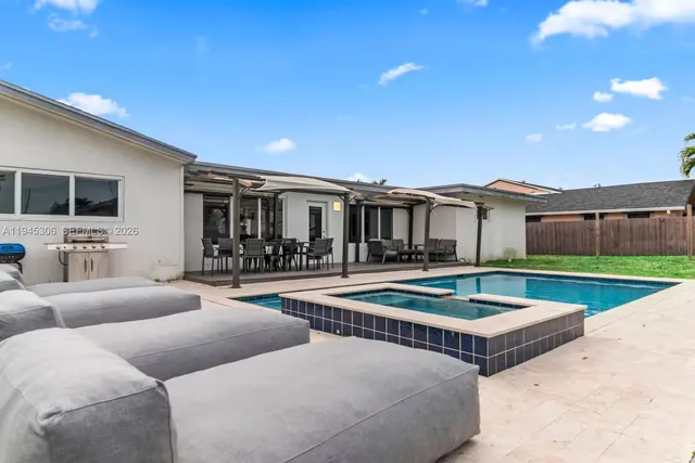 a view of a patio with swimming pool table and chairs