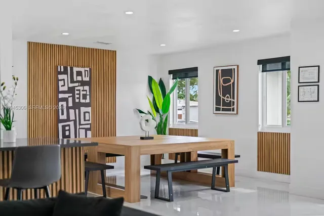 a view of a dining room with furniture and a potted plant