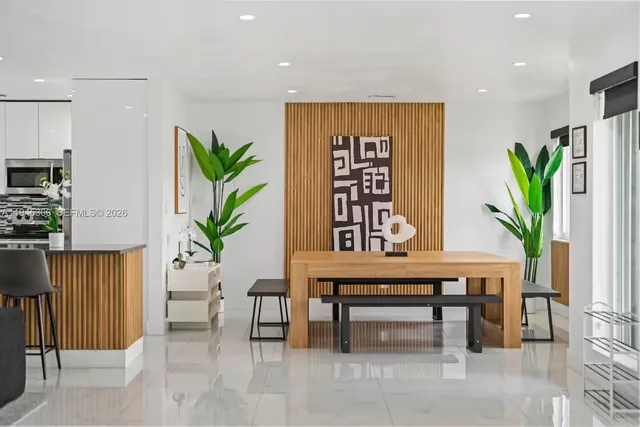 a living room with furniture potted plant and a window