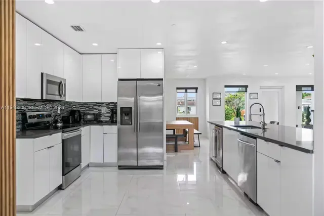 a kitchen with a sink stainless steel appliances and cabinets