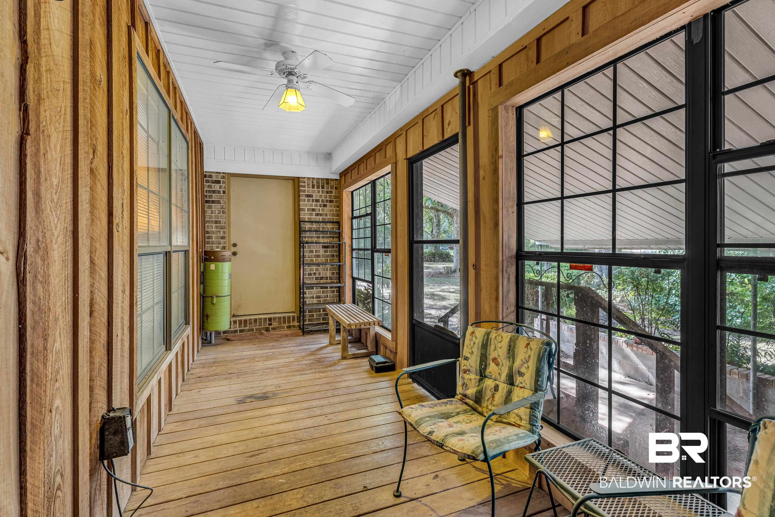 72075 Highway 59 Little River, AL 36550 - Photo 28 of 40 Sunroom / solarium featuring hardwood / wood-style floors and brick wall