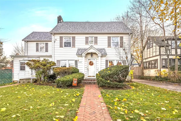 a front view of a house with large garden