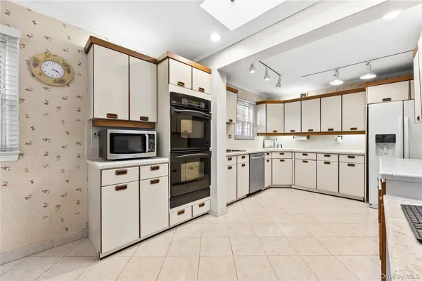 a kitchen with stainless steel appliances a stove a sink and a refrigerator