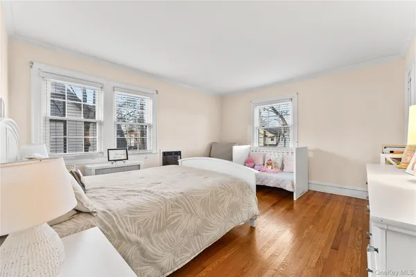 a bedroom with furniture and a large window