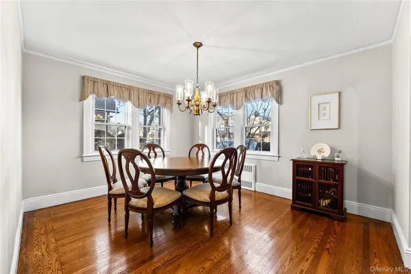a view of a dining room with furniture and chandelier