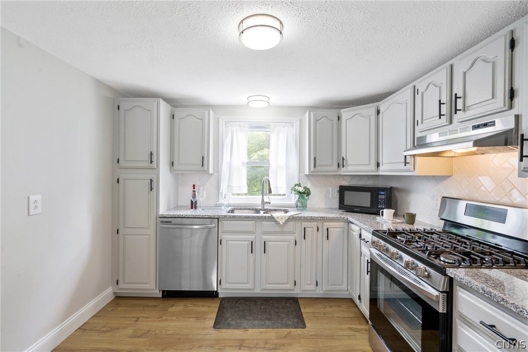 6130 South Bay Road Cicero, NY 13039 - Photo 11 of 30 An outlet at left higher up in the wall provides the opportunity to place a small rolling island or credenza for other small kitchen appliances if you'd like.