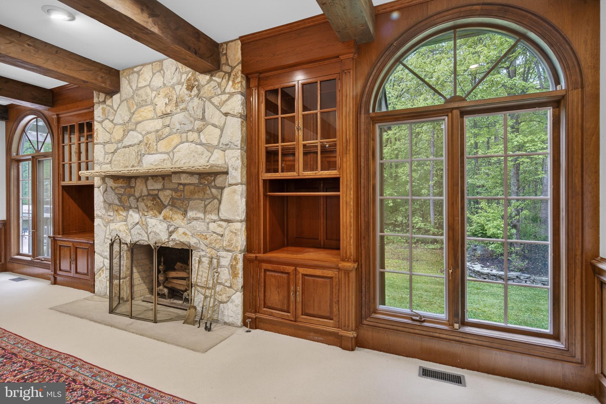 255 Arreton Road Princeton, NJ 08540 - Photo 20 of 65 a living room with a fireplace and a large window