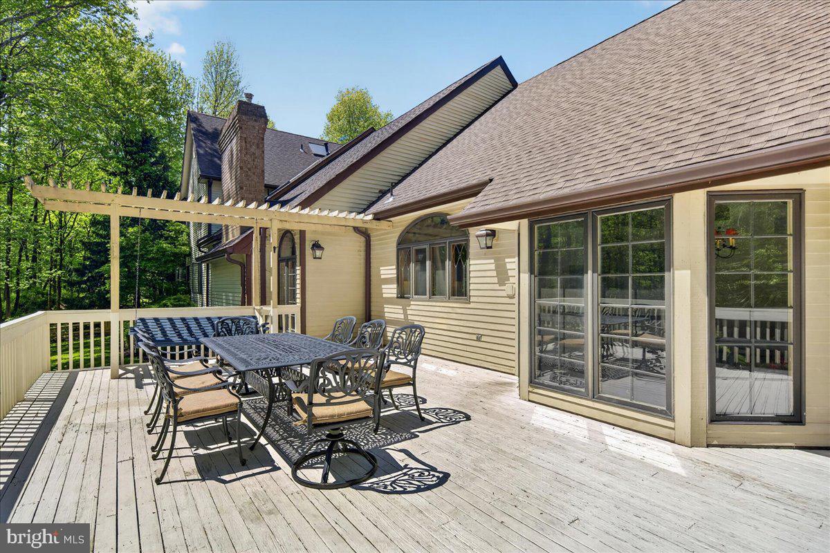 255 Arreton Road Princeton, NJ 08540 - Photo 55 of 65 a roof deck with table and chairs and wooden floor
