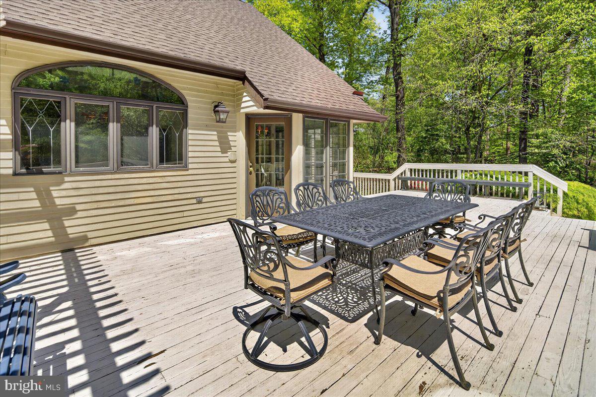 255 Arreton Road Princeton, NJ 08540 - Photo 56 of 65 a view of a patio with table and chairs with wooden floor and fence