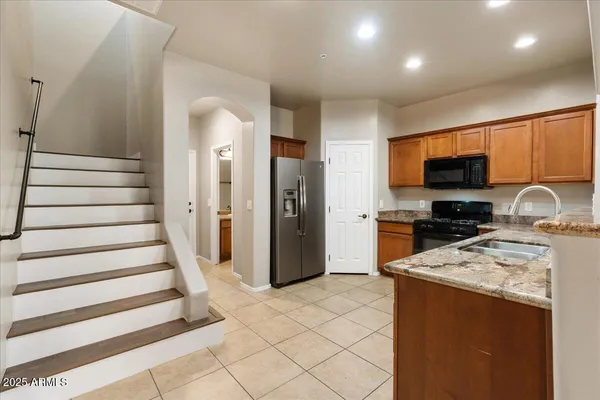 a kitchen with a refrigerator and a sink