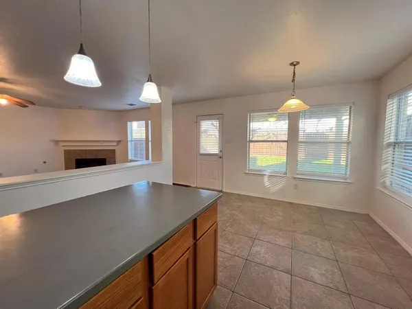a kitchen with a sink and chandelier