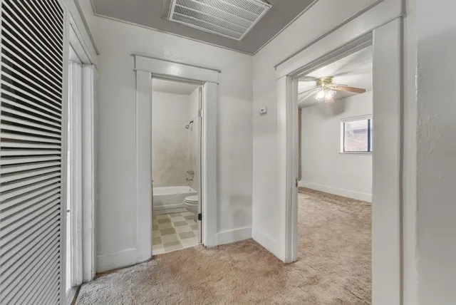 an empty room with mirror in it