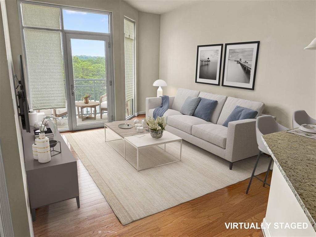 711 Cosmopolitan Drive Northeast, Unit 527 Atlanta, GA 30324 - Photo 2 of 9 a living room with furniture and large window