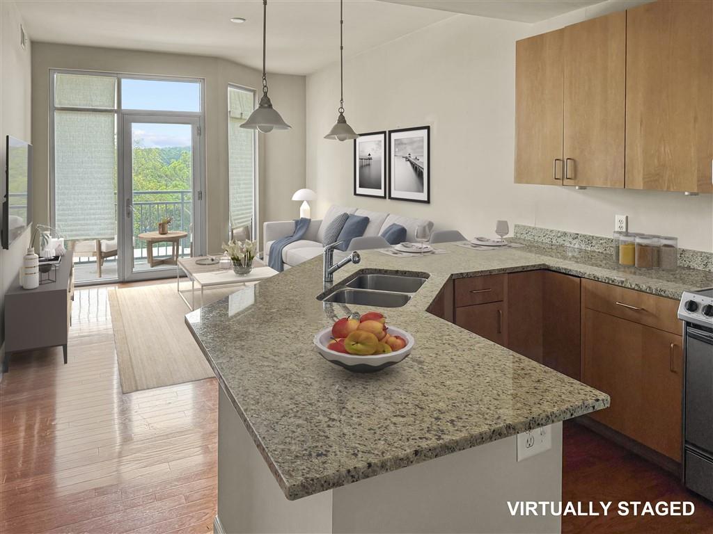 711 Cosmopolitan Drive Northeast, Unit 527 Atlanta, GA 30324 - Photo 4 of 9 a kitchen with a granite countertop sink a stove and white cabinets