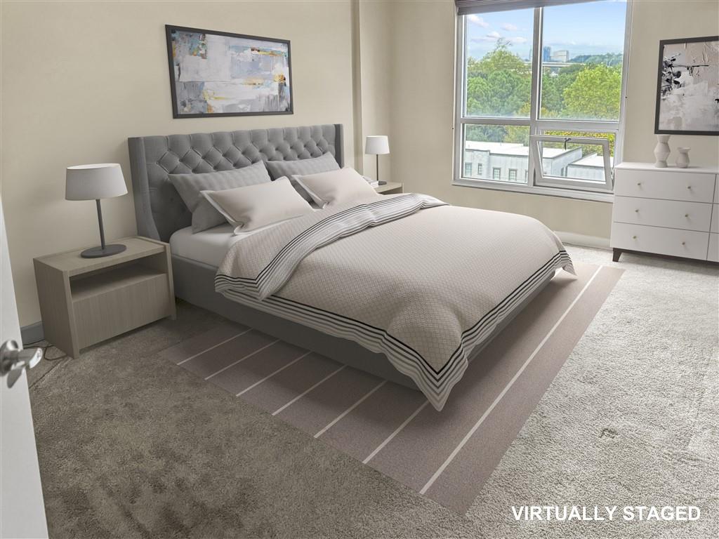 711 Cosmopolitan Drive Northeast, Unit 527 Atlanta, GA 30324 - Photo 6 of 9 a bedroom with a bed and a large window