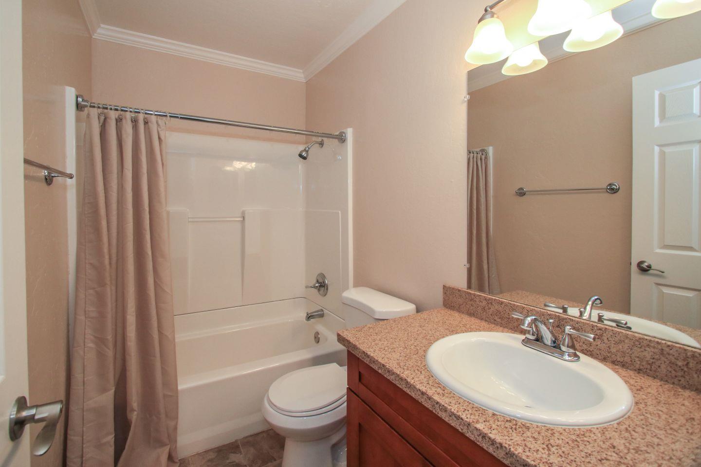 837 Spruance Lane Foster City, CA 94404 - Photo 18 of 32 a bathroom with a granite countertop sink toilet and shower