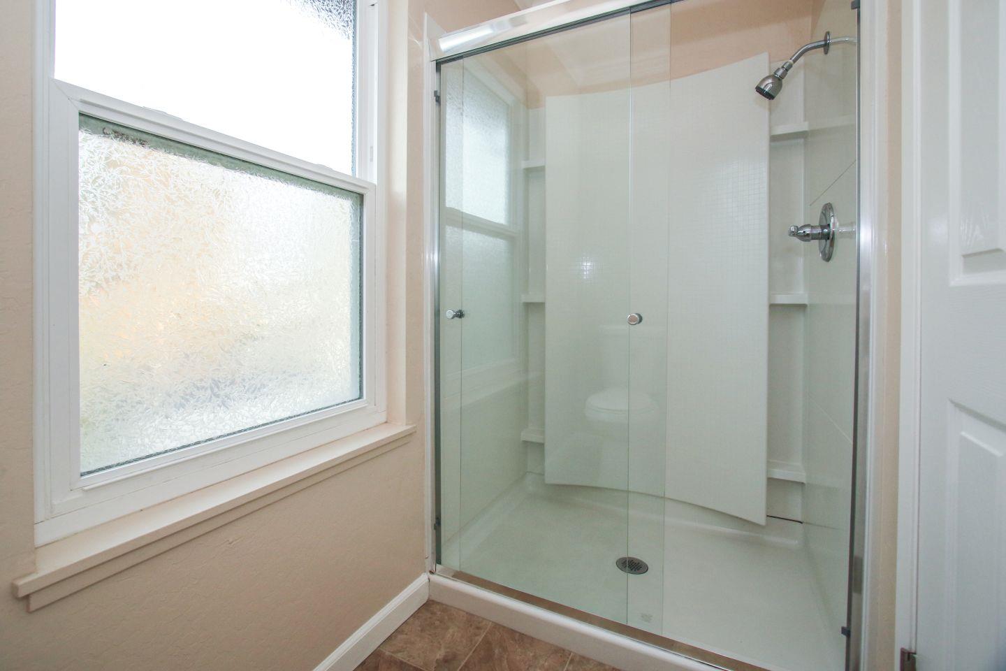837 Spruance Lane Foster City, CA 94404 - Photo 23 of 32 a bathroom with a glass shower door