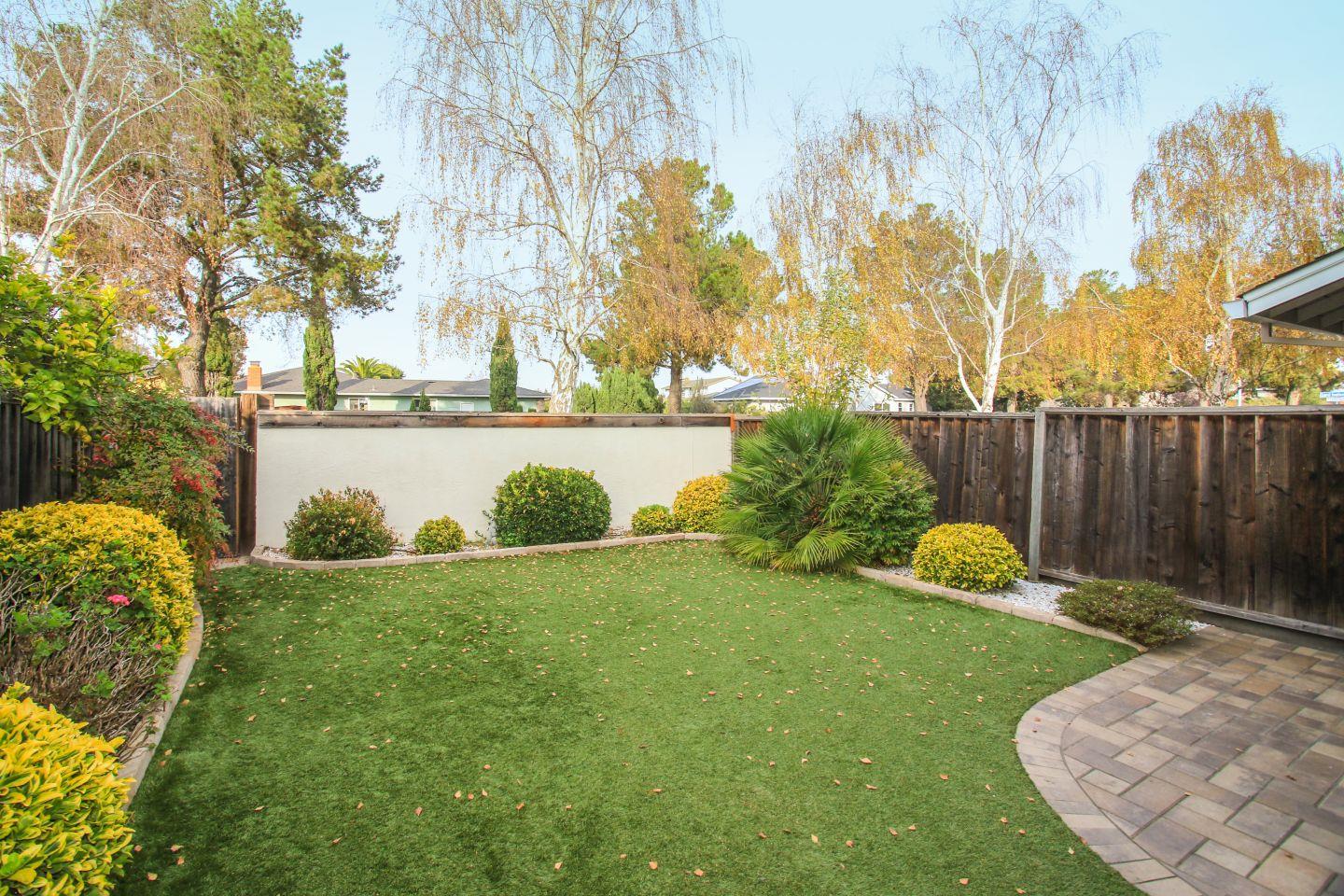 837 Spruance Lane Foster City, CA 94404 - Photo 28 of 32 a view of a backyard with seating area and green space