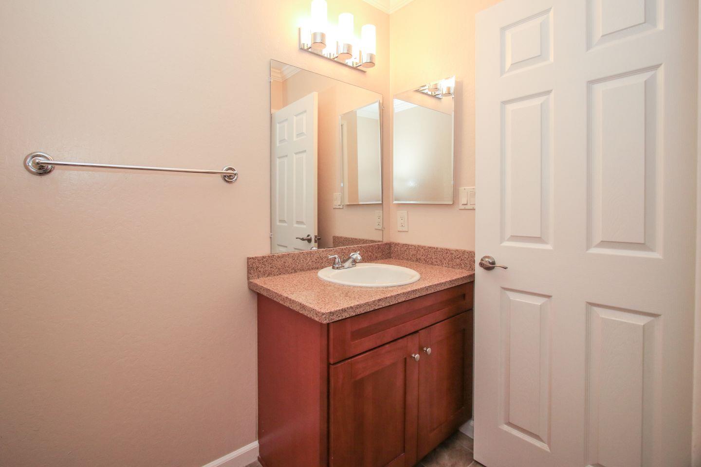 837 Spruance Lane Foster City, CA 94404 - Photo 10 of 32 a bathroom with a granite countertop sink and a mirror
