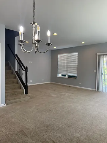 a view of a room with stairs and wooden floor