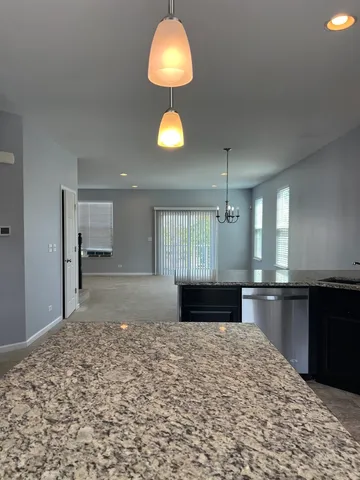 a view of kitchen with granite countertop cabinets and wooden floor