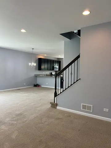 a view of an empty room with windows