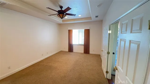 a view of a livingroom with a ceiling fan and window