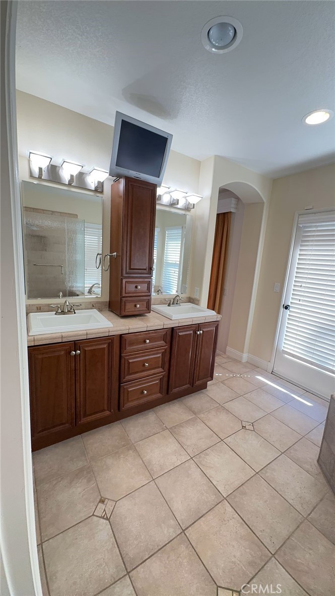 38265 Birch Court Murrieta, CA 92562 - Photo 15 of 46 a bathroom with a double vanity sink and a mirror