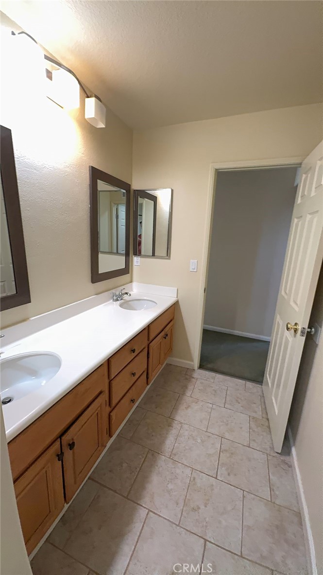 38265 Birch Court Murrieta, CA 92562 - Photo 30 of 46 a spacious bathroom with a sink a mirror and a vanity
