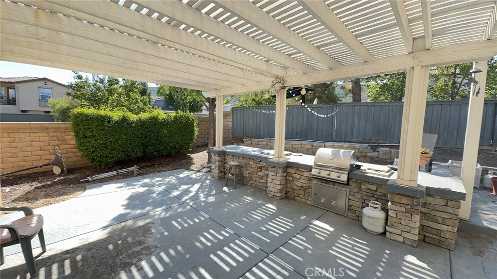 38265 Birch Court Murrieta, CA 92562 - Photo 43 of 46 a view of a patio with table and chairs potted plants with wooden floor and fence