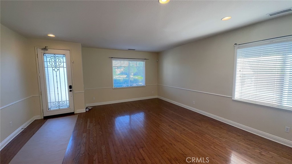 38265 Birch Court Murrieta, CA 92562 - Photo 5 of 46 an empty room with wooden floor and windows